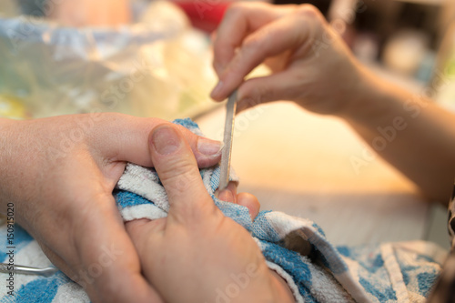 Female manicure on hands in a beauty salon