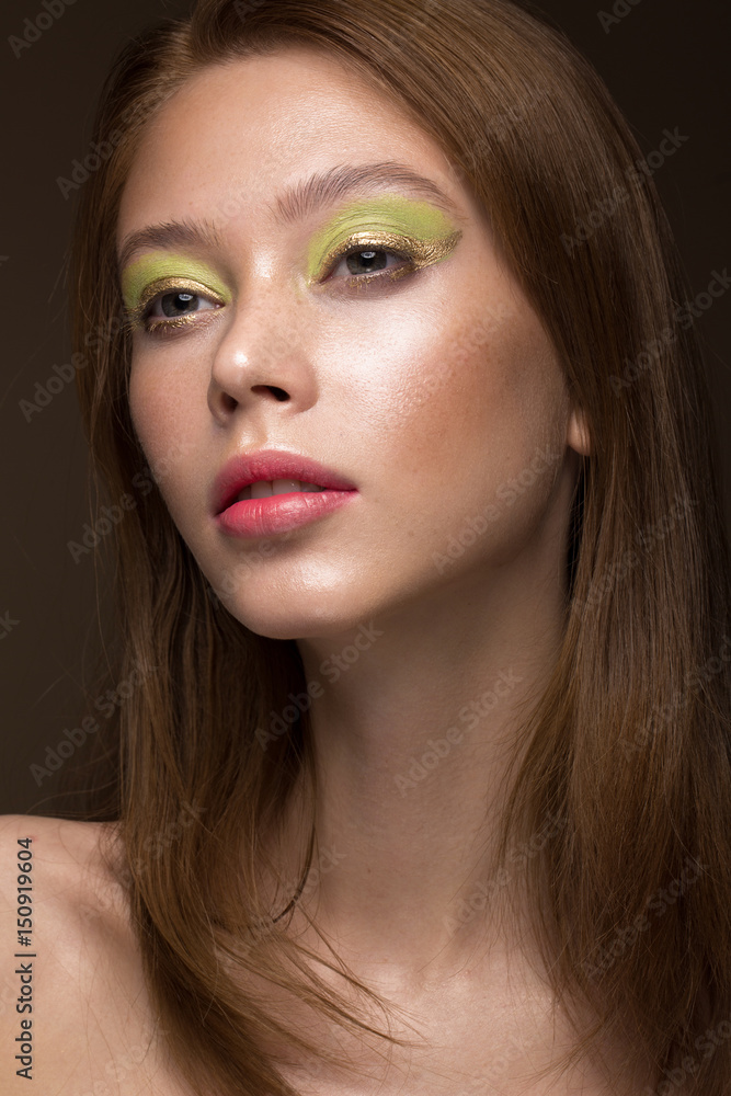 Obraz premium Beautiful red-hair girl with creative green makeup. Beauty face. Photos shot in studio