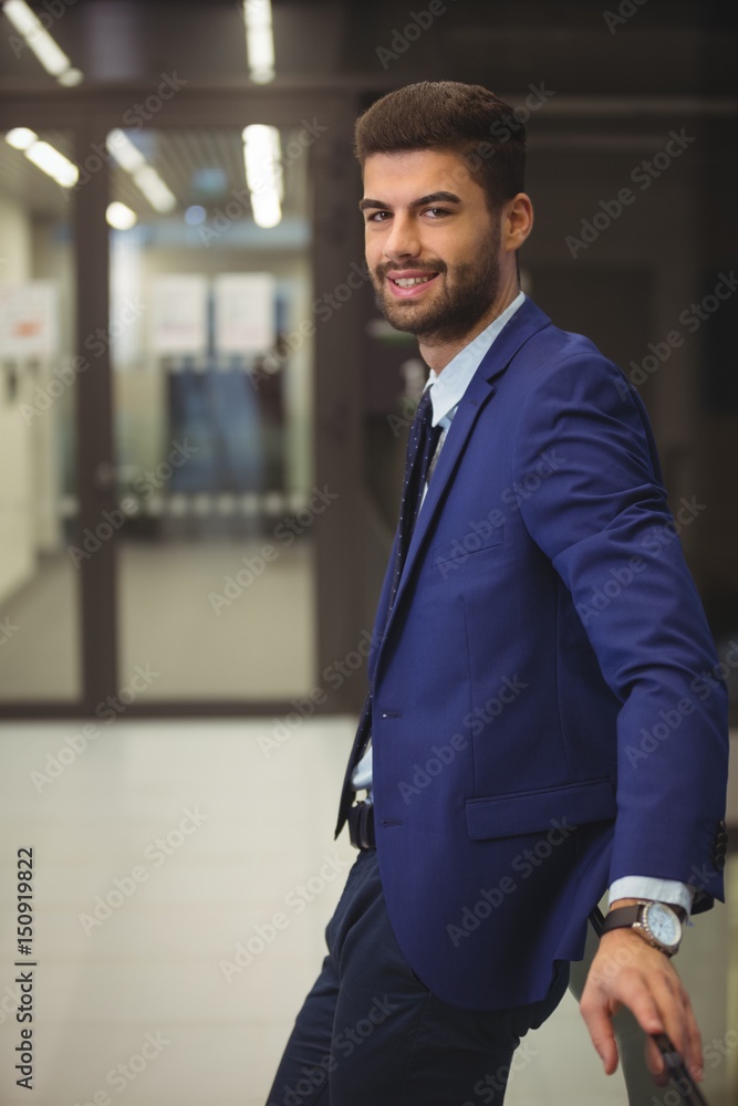 Portrait of handsome businessman standing in corridor Portrait of handsome businessman standing in corridor