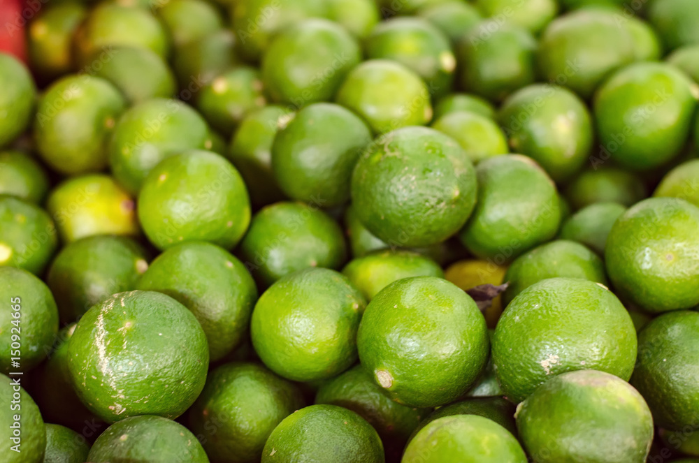 Green lime display at fresh market stall background. Green lime display at fresh market stall background.