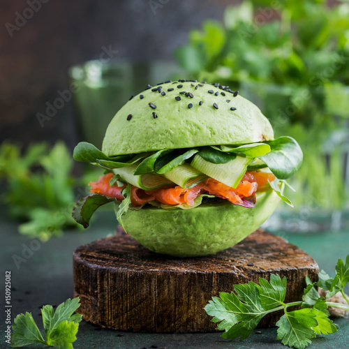 avocado burger with salted salmon and fresh vegetables photo