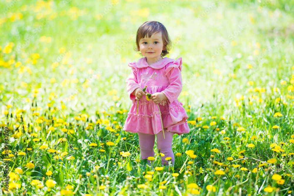Girl in pink dress with dandelion on green grass. Girl in pink dress with dandelion on green grass.