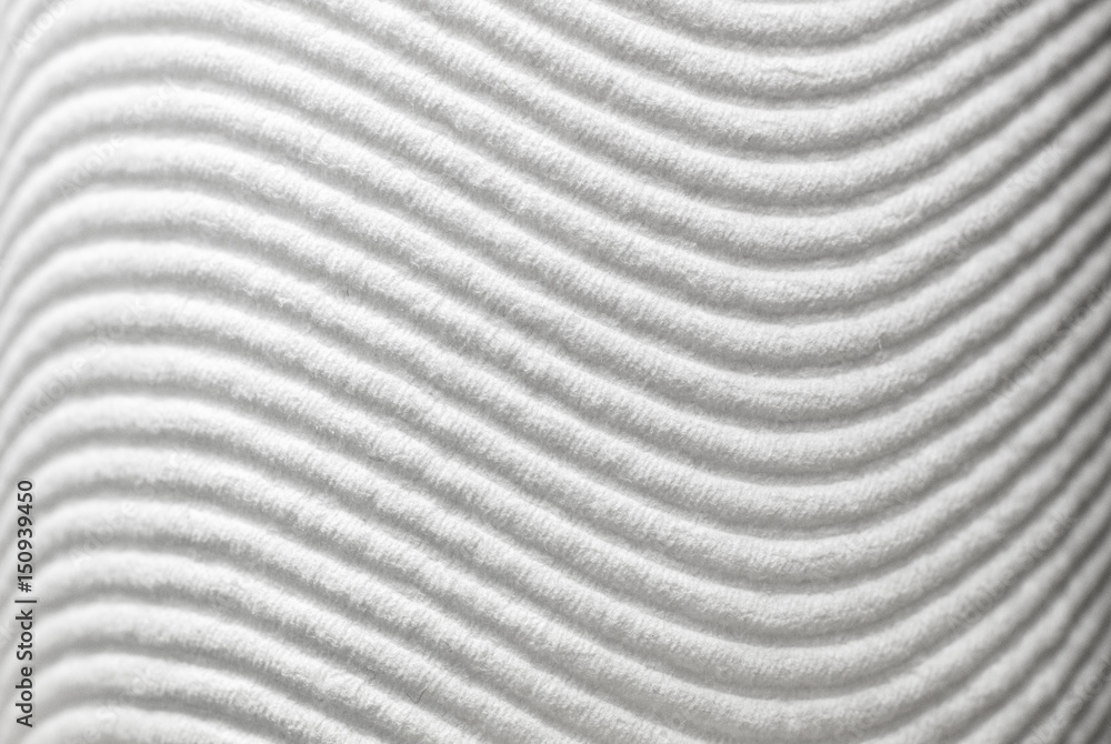 Wavy patterns in white textured paper surface Wavy patterns in white textured paper surface
