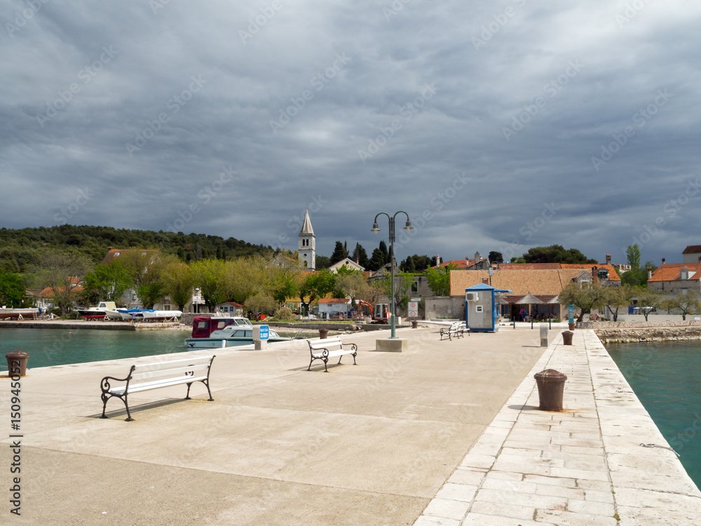 Fototapeta premium Town pier in Zlarin island in Croatia, port marine with yachts and catamarans