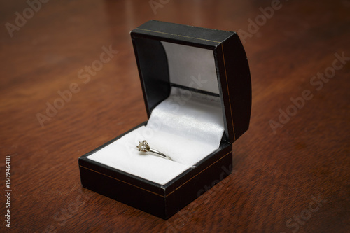 a ring box with a diamond engagement ring in it © heller181