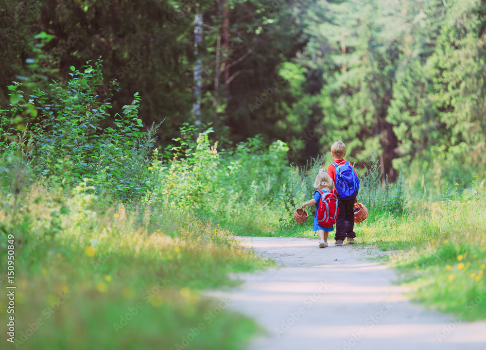 Fototapeta premium little boy and girl walking in forest