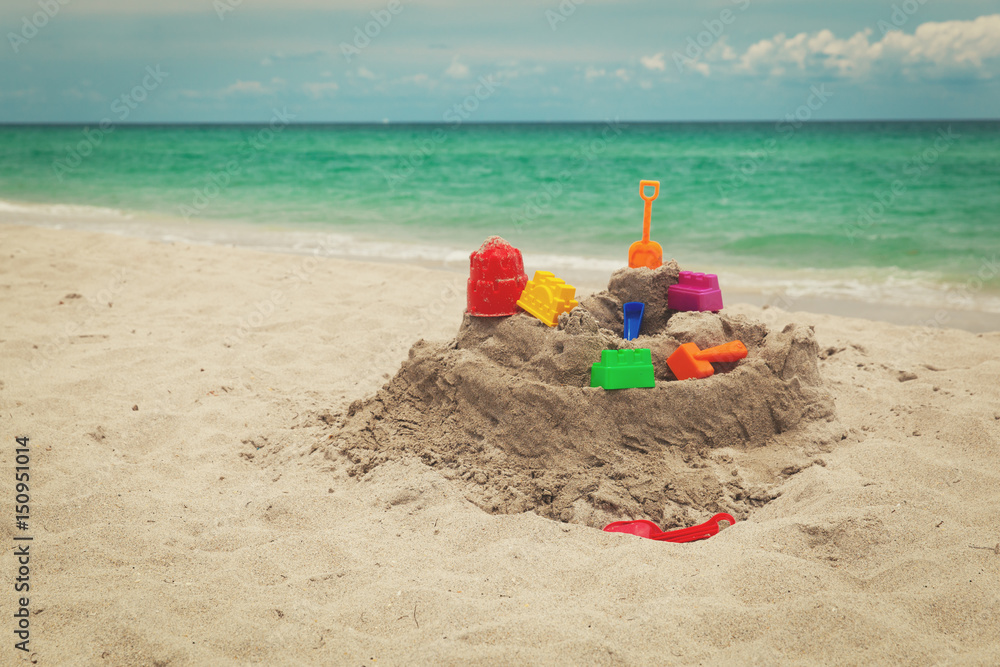 Sand castle on beach and kids toys Sand castle on beach and kids toys