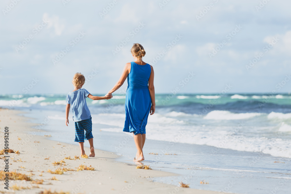 mother and son walking on beach