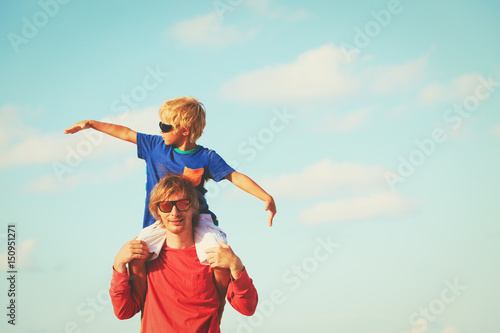 father and son having fun on sky