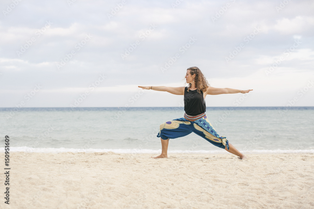 Woman practicing yoga on the beach Woman practicing yoga on the beach