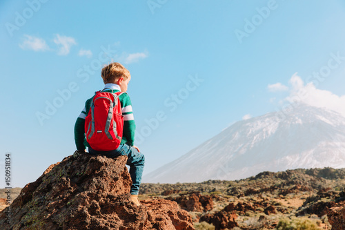 little boy hiking in mountains
