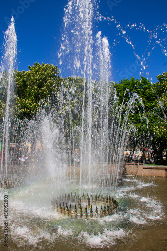 Splashes of fountain water in city park