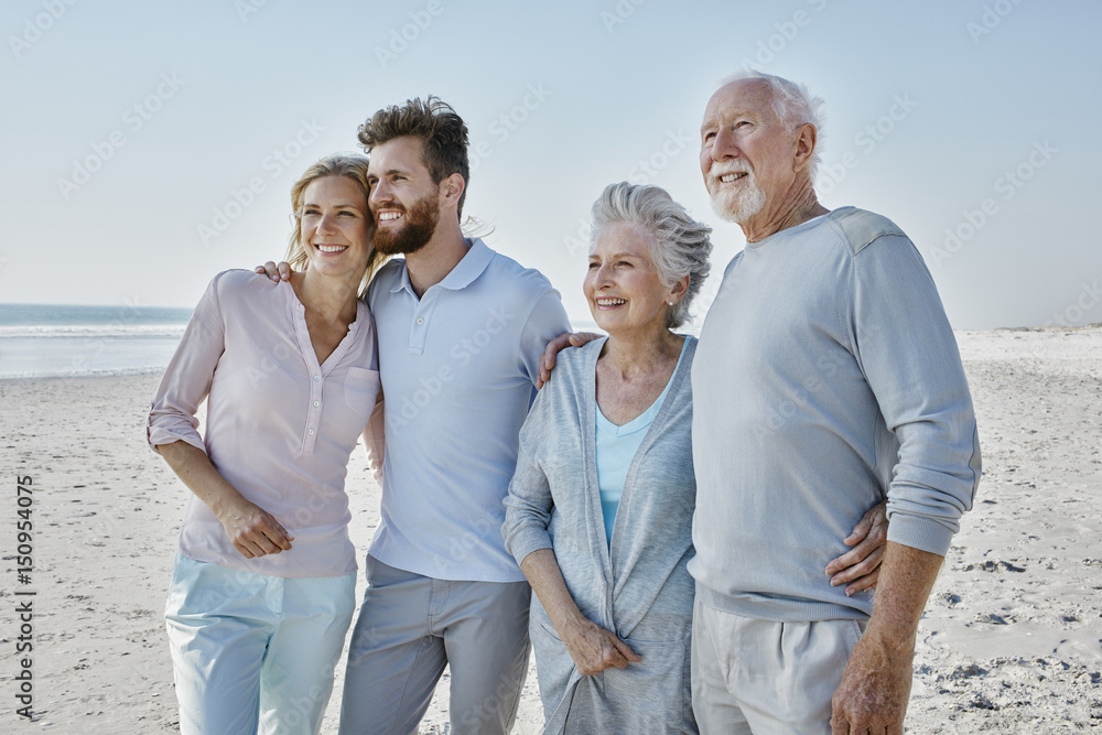 Smiling senior couple with adult children on the beach Smiling senior couple with adult children on the beach