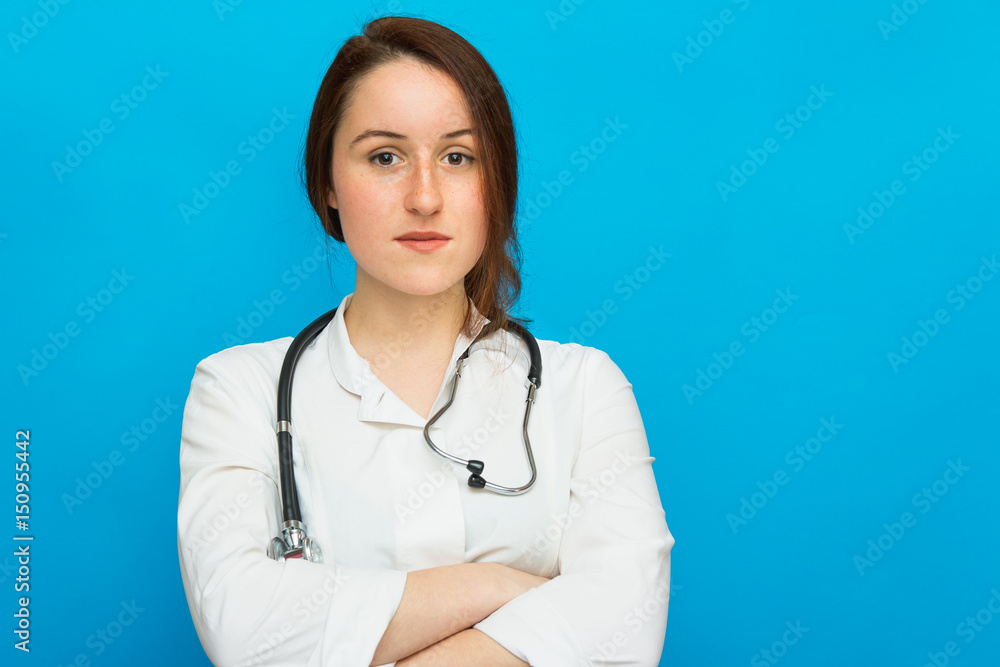 Beautiful female doctor with stethoscope on blue background Beautiful female doctor with stethoscope on blue background