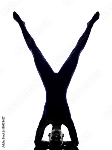 woman exercising vrschikasana scorpion pose yoga silhouette shadow white background