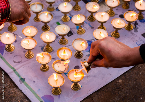 Nepali people lighting oil lamps on day of Vesak, Visaka, people praying for world peace and those who died on massive earthquake on 25 april 2015 in Nepal photo