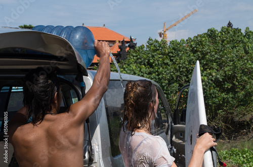 Female surfer having improvised shower after surf session at Batu Bolong photo