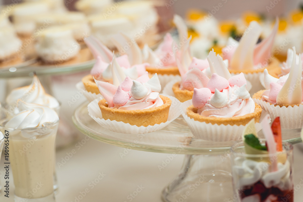 glass stand with cupcakes on a wedding candy bar table glass stand with cupcakes on a wedding candy bar table