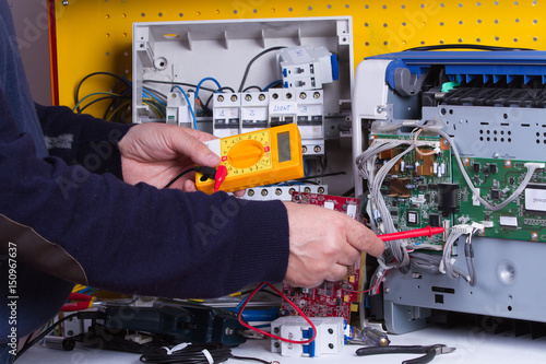 electrician fixing electrical device