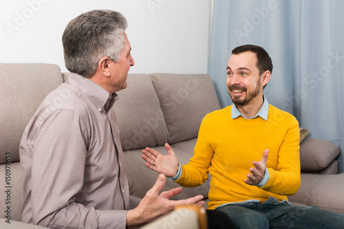 Tableau sur toile Adult father and son friendly conversation