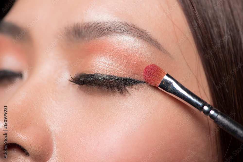 Beautiful asian woman face with perfect makeup applying blusher. Beautiful asian woman face with perfect makeup applying blusher.