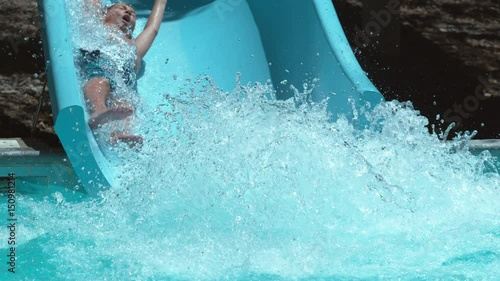 Boy going down waterslide in super slow motion