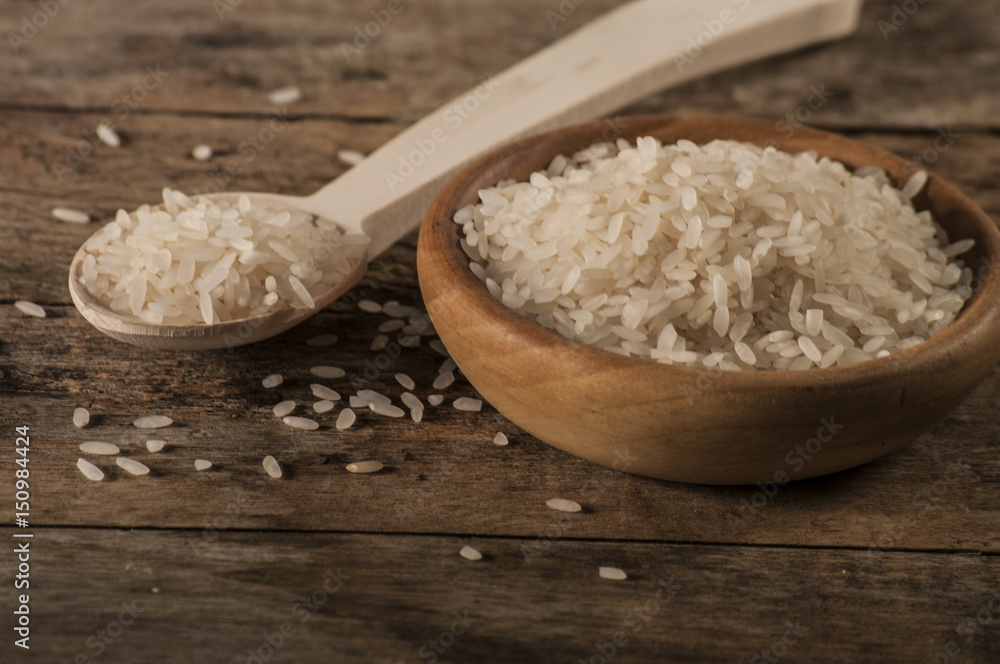 a bowl of rice on wooden surface a bowl of rice on wooden surface