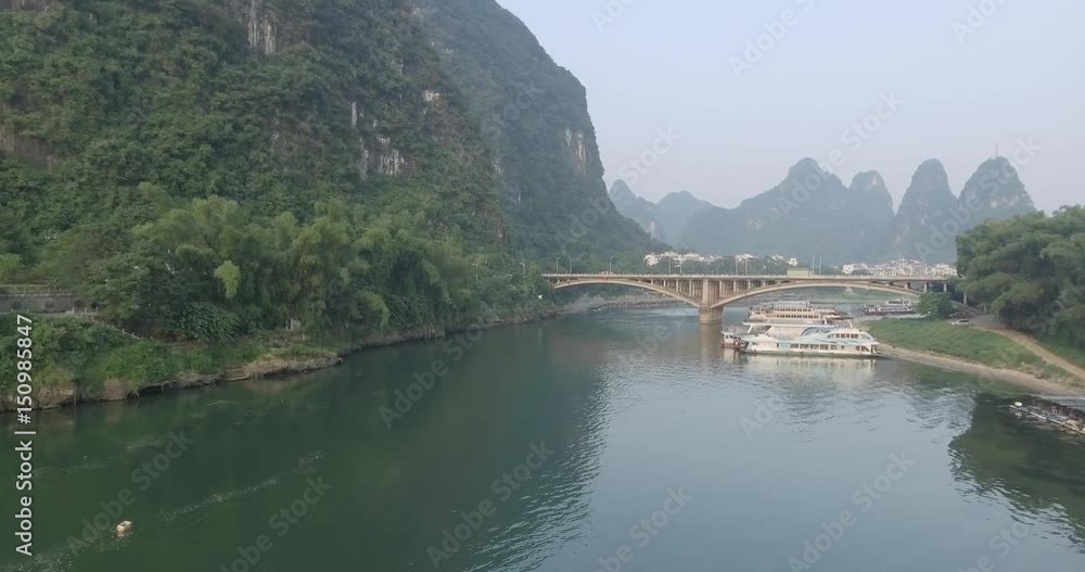 Aerial view of sunrise over karst mountain landscape in Yangshuo, Guanxi province, China. Li River top view. Travel, adventure and picturesque famous destination concept. Aerial view of sunrise over karst mountain landscape in Yangshuo, Guanxi province, China. Li River top view. Travel, adventure and picturesque famous destination concept.
