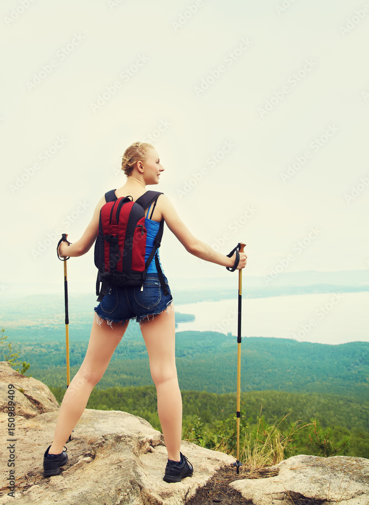 woman with backpack hiking in the mountains