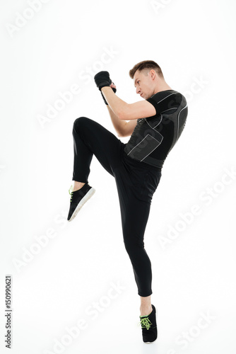 Portrait of a young healthy athlete man doing boxing exercises