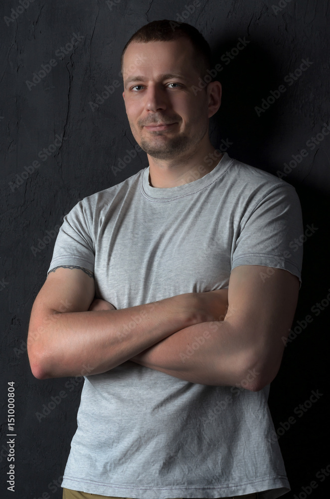 Attractive young man with arms crossed on his chest Attractive young man with arms crossed on his chest