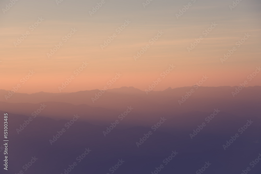 beautiful sunset and foggy mountain valley landscape.