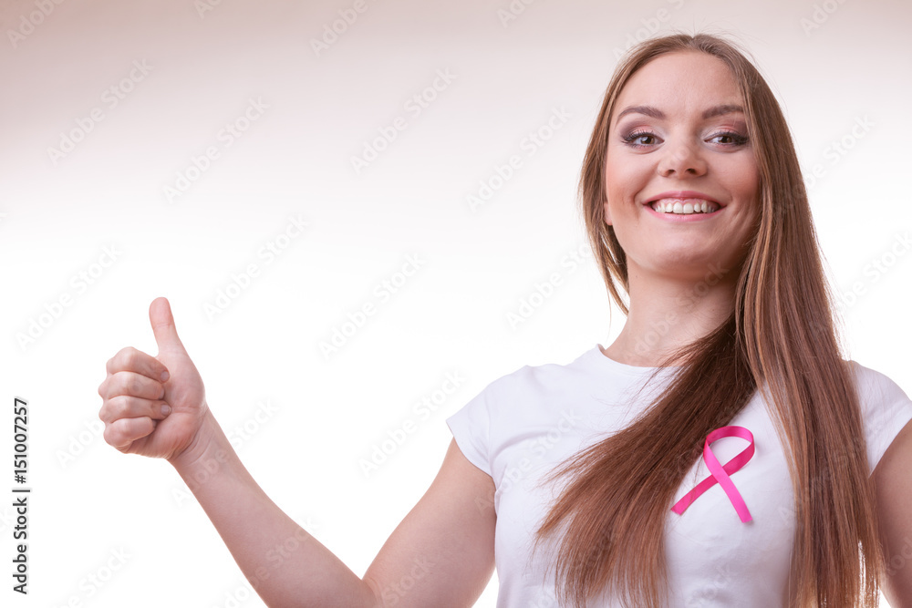 woman pink cancer ribbon on chest making thumb up woman pink cancer ribbon on chest making thumb up