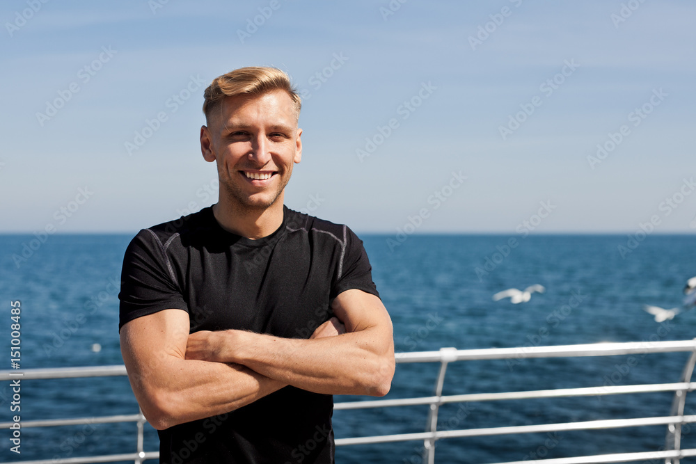 Cheerful man standing on pier