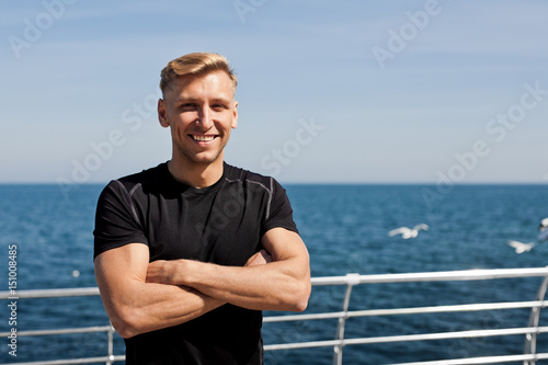 Cheerful man standing on pier