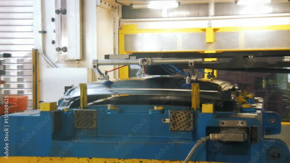 press machine is making details for production car body from metal sheets, robotic production press machine is making details for production car body from metal sheets, robotic production