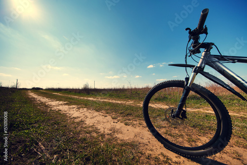 Mountain biking down hill descending fast on bicycle. View from bikers eyes.