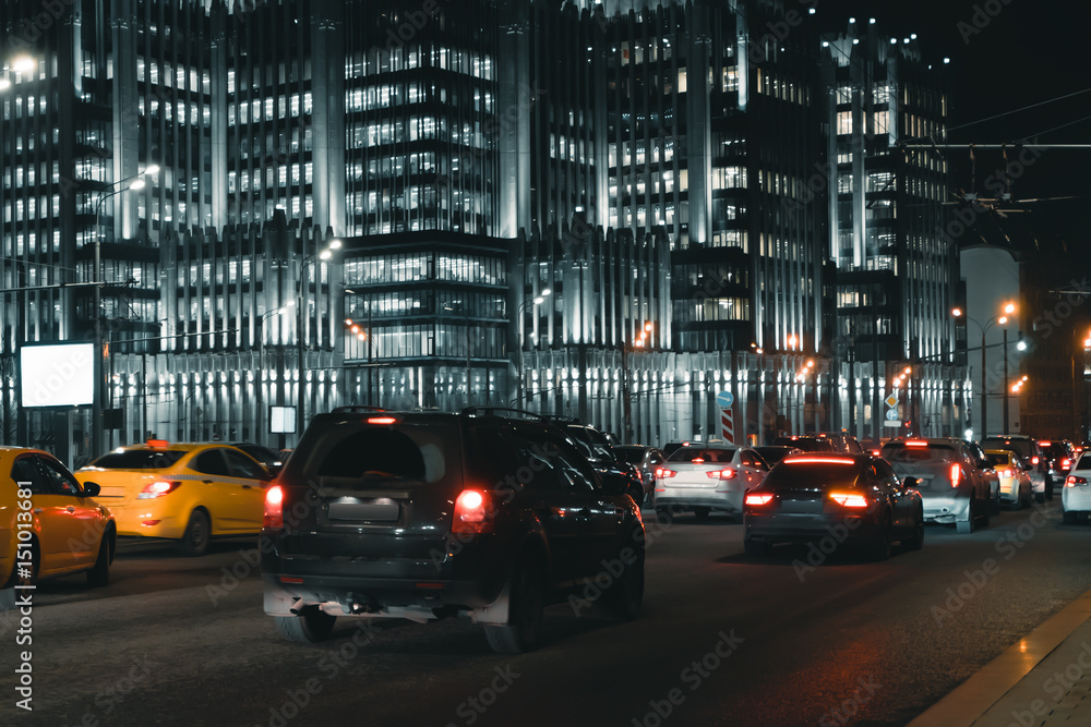 Cars in motion on the road in night city