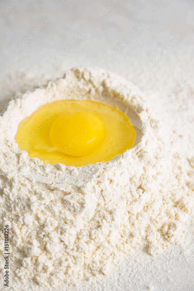 Flour and egg on the white table. Selective focus. Flour and egg on the white table. Selective focus.