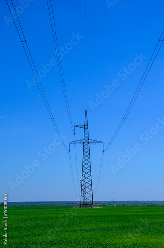 High voltage power line against sky