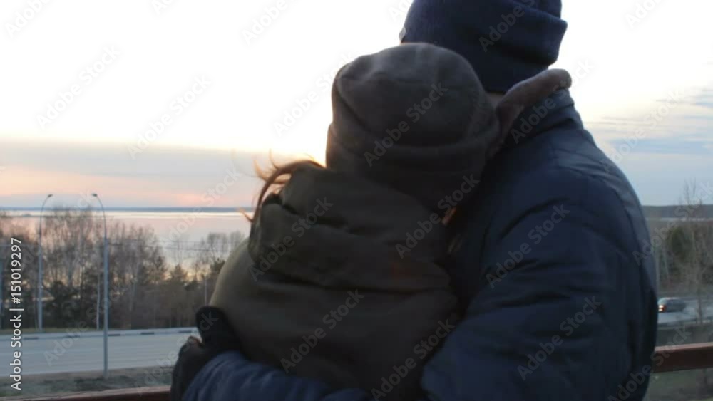 Romantic young couple hugging enjoying sunset on the roof terrace cityscape Romantic young couple hugging enjoying sunset on the roof terrace cityscape