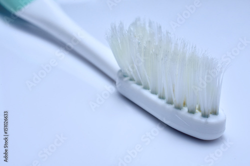 Old toothbrushes wear out on white background.