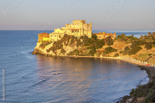 Sunrise on turquoise sea frames the medieval Falconara Castle, Butera, Province of Caltanissetta, Sicily, Mediterranean