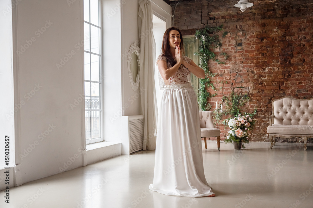 Beautiful brunette girl in dress posing in the interior, room, hotel Beautiful brunette girl in dress posing in the interior, room, hotel