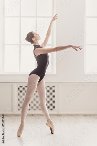 Beautiful ballerina stands in ballet position