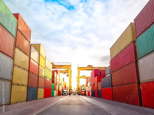 The RTG(Rubber Tried Gantry Cranes) pick up full loaded containers on truck at industrial port and container yard   for delivery to customers photo