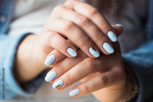 beautiful manicure. Gel polish coating in blue, embossing. photo