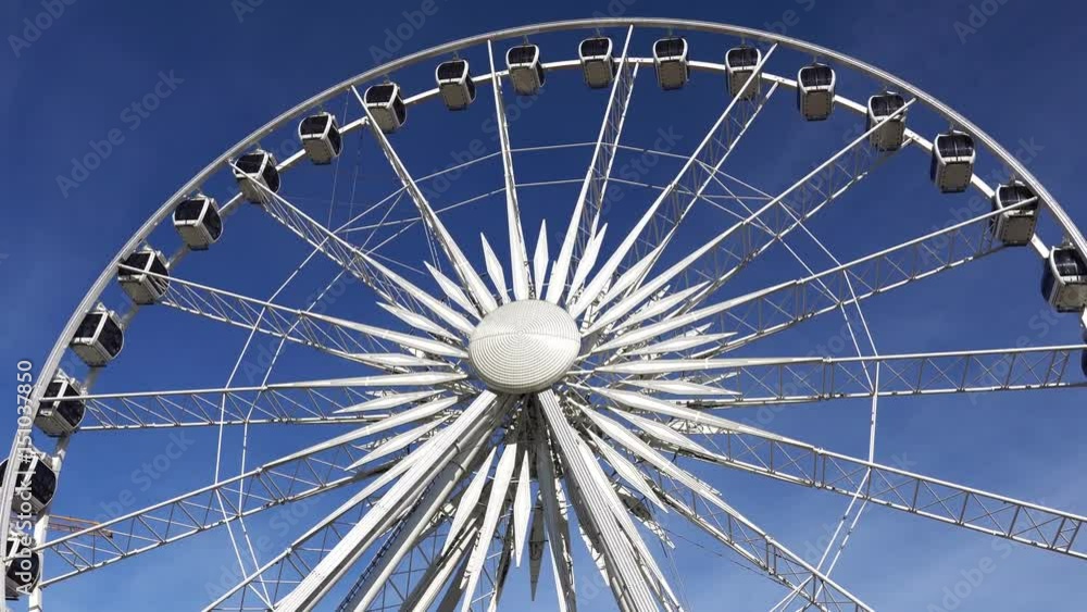 Ferris wheel rotating on blue sky background. Ferris wheel rotating on blue sky background.