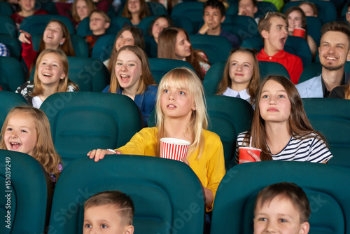 Cinema auditorium full of children during cartoon premiere people lifestyle leisure activity weekend holidays teens preteens fun hobby films relaxing comfortable carefree positivity concept. © serhiibobyk