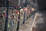 Love locks hanging on a bridge railing